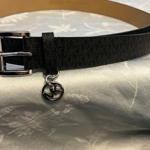 Black Michael Kors belt with silver metal accents. 45 1/2” total length